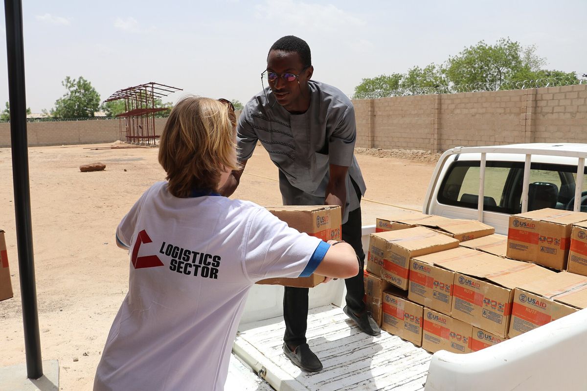 Aid workers loading relief supplies from a pickup truck in northern Nigeria
